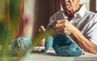 older man knitting