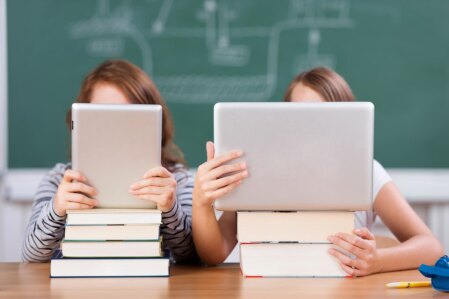 two students reading on tablets